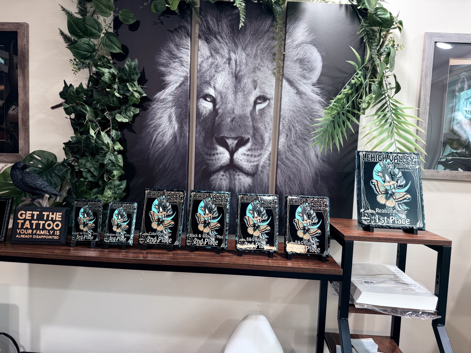 The shelf of awards Adam won for his tattoo studio
